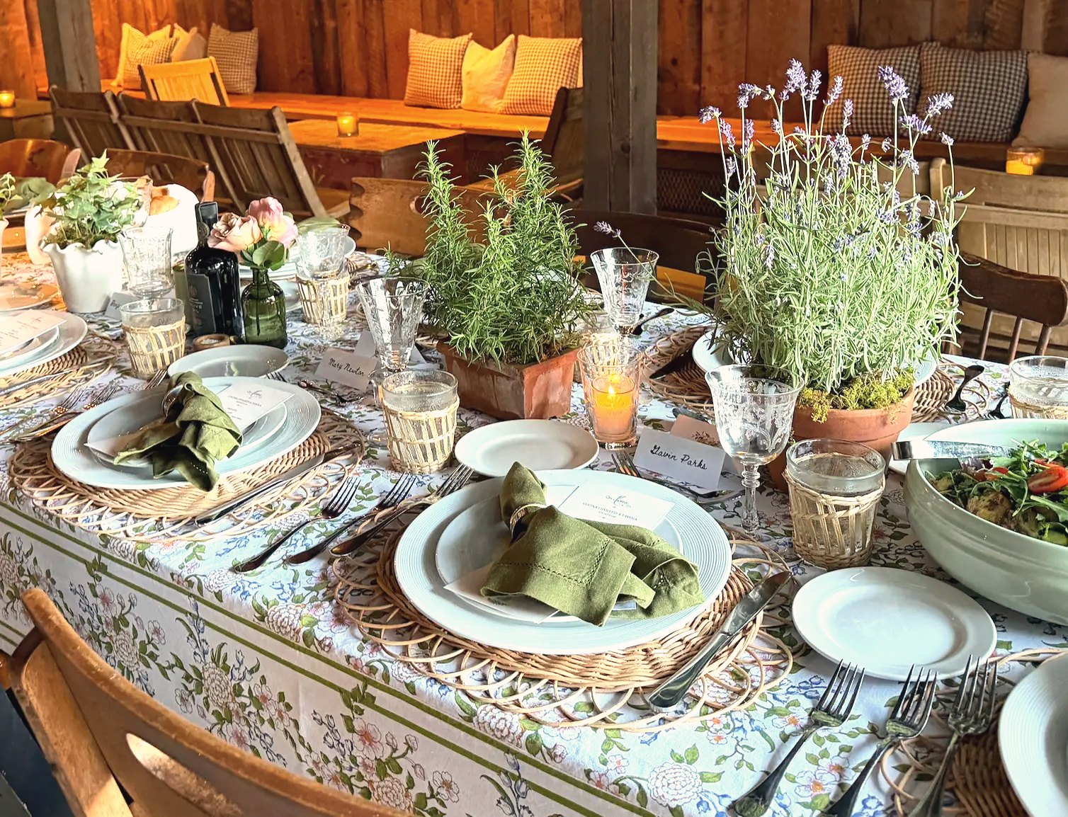 A table dressed with potted herbs and candles at a recent event